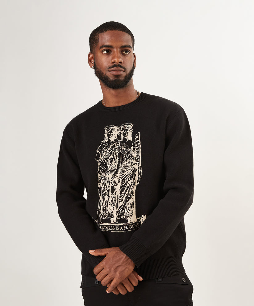 CUSTOM_ALT_TEXT: Male model wearing Paper Planes Birdseye Statue Crewneck Sweater.