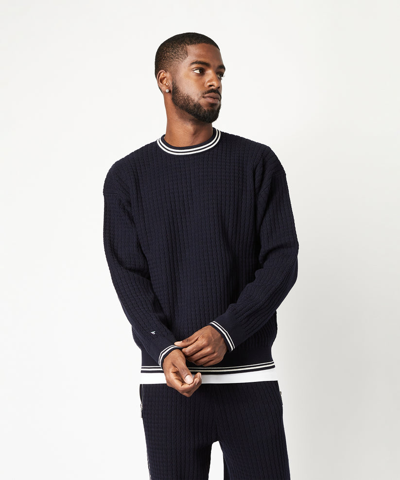 CUSTOM_ALT_TEXT: Male model wearing Paper Planes Racked Rib Sweater, color Parisian Night.