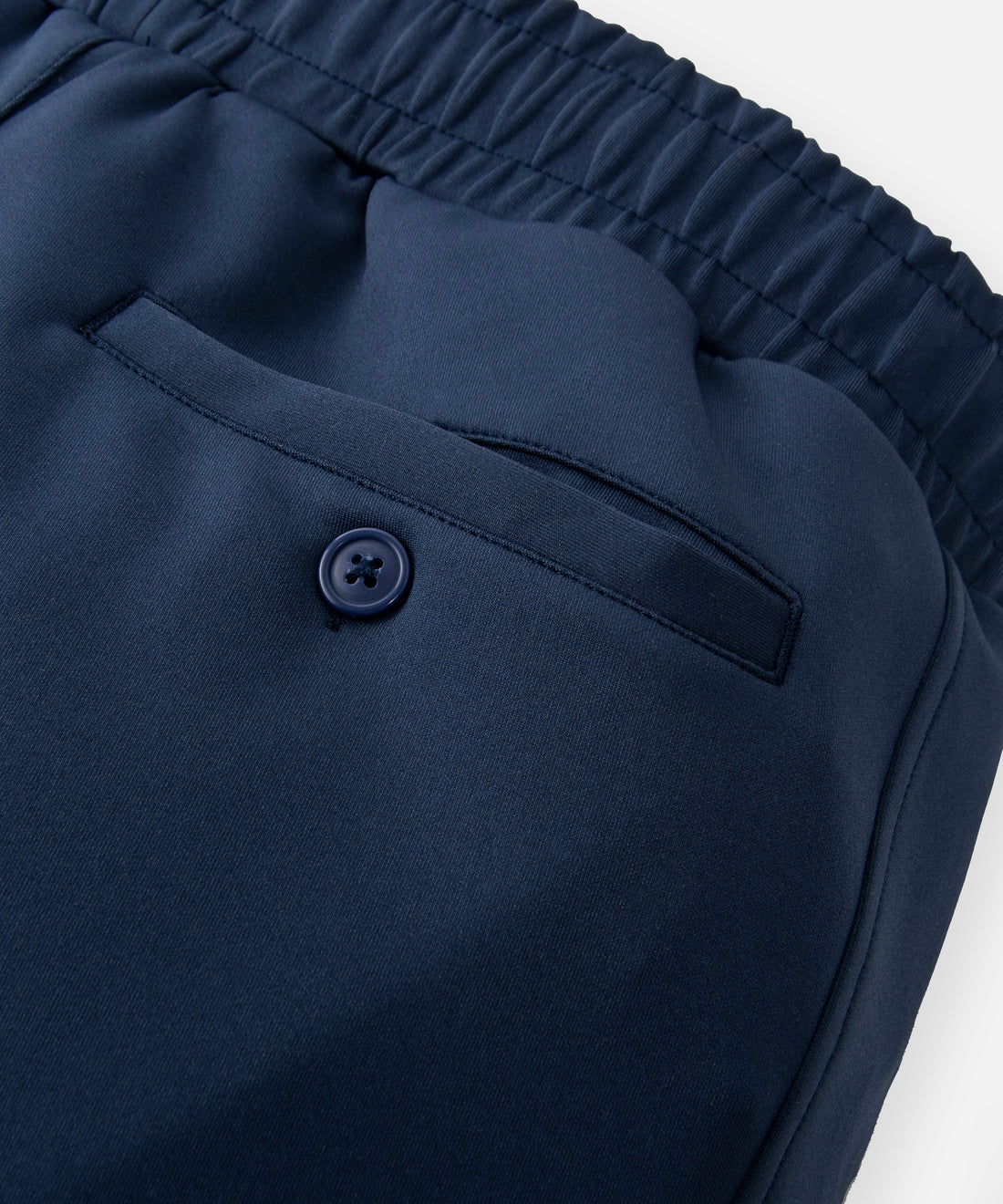 CUSTOM_ALT_TEXT: Single welt button-through back pocket on Paper Planes Slim Fit Chromatic Jogger color Naval Academy.