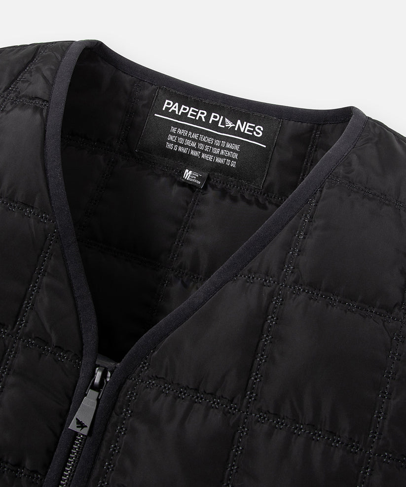 CUSTOM_ALT_TEXT: Binded neckline detail on Paper Planes All-Purpose Quilted Vest, color Black.