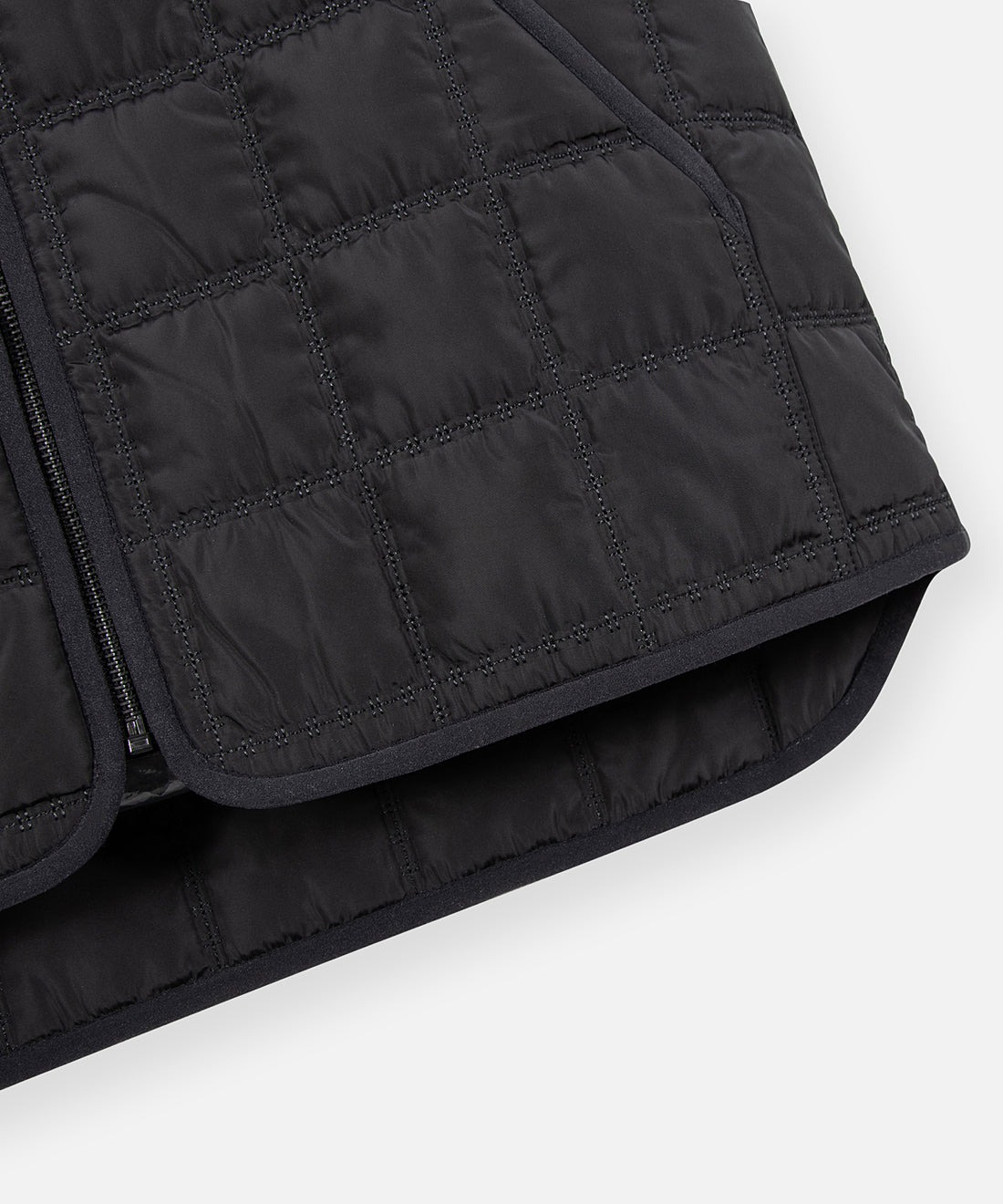 CUSTOM_ALT_TEXT: Binded hem detail on Paper Planes All-Purpose Quilted Vest, color Black.