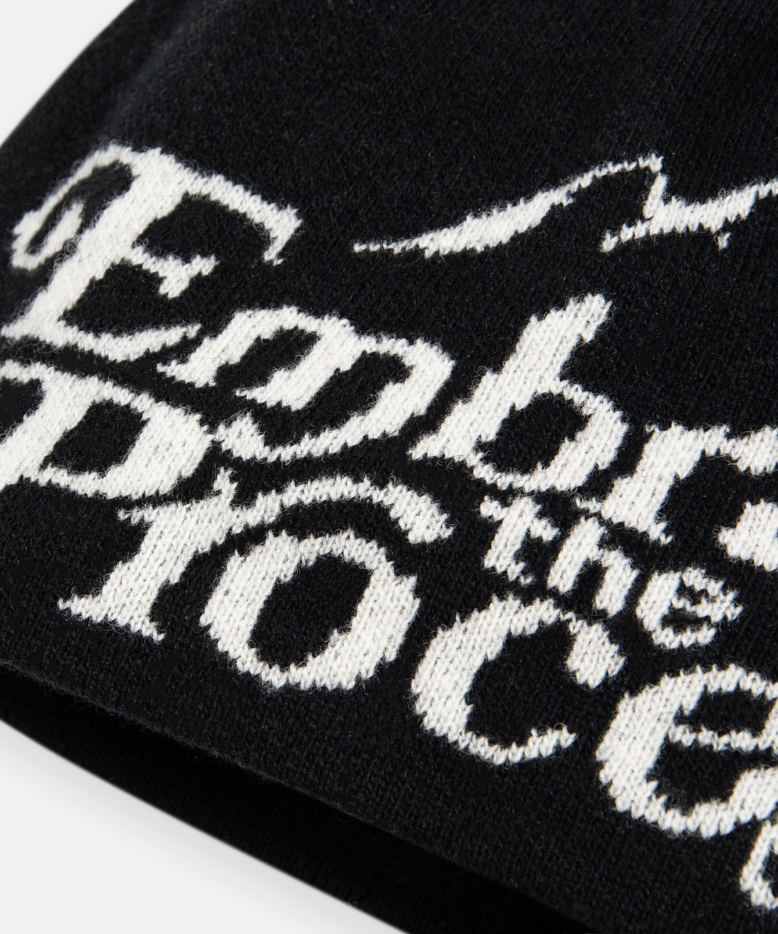 CUSTOM_ALT_TEXT: Closeup of jacquard artwork on Paper Planes Embrace the Process Beanie.