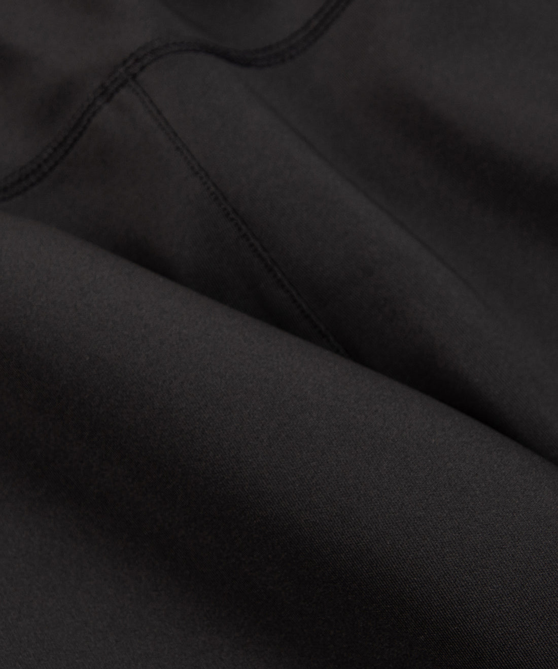 CUSTOM_ALT_TEXT: Interlock fabric closeup on Paper Planes Utility Pocket Pant, color Black.