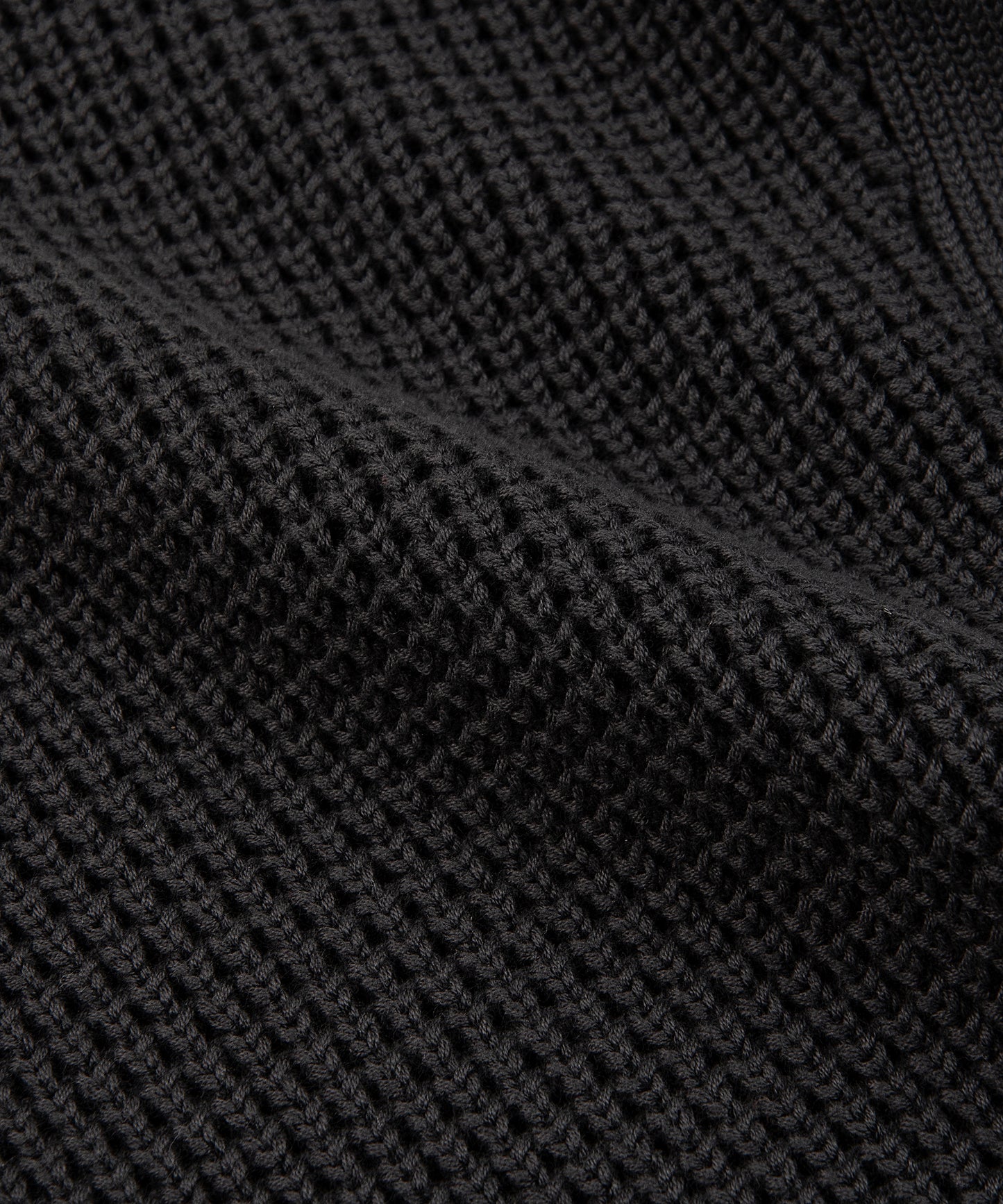 CUSTOM_ALT_TEXT: Closeup of waffle stitch on Paper Planes Sweater Knit Jogger, color Pirate Black.