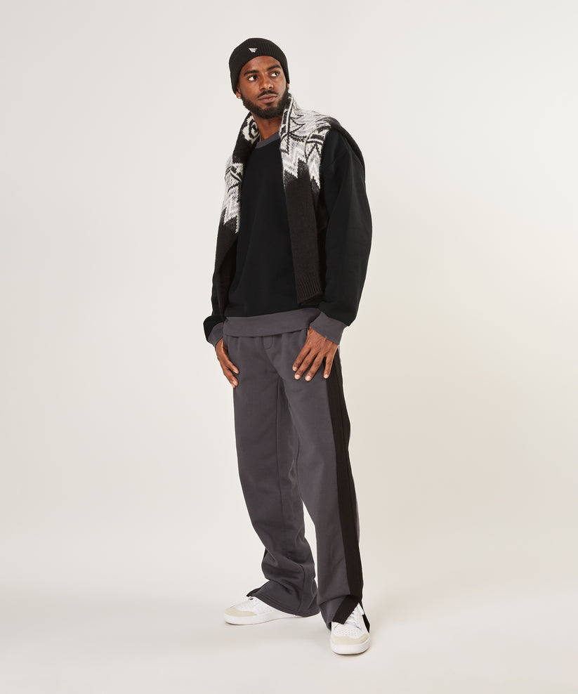 CUSTOM_ALT_TEXT: Male model wearing Paper Planes Dream Lab Sweatpant, color Asphalt.