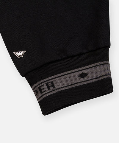 CUSTOM_ALT_TEXT: Plane metal with enamel rivet and jacquard logo cuff on Paper Planes Logo Jacquard Hoodie, color Black