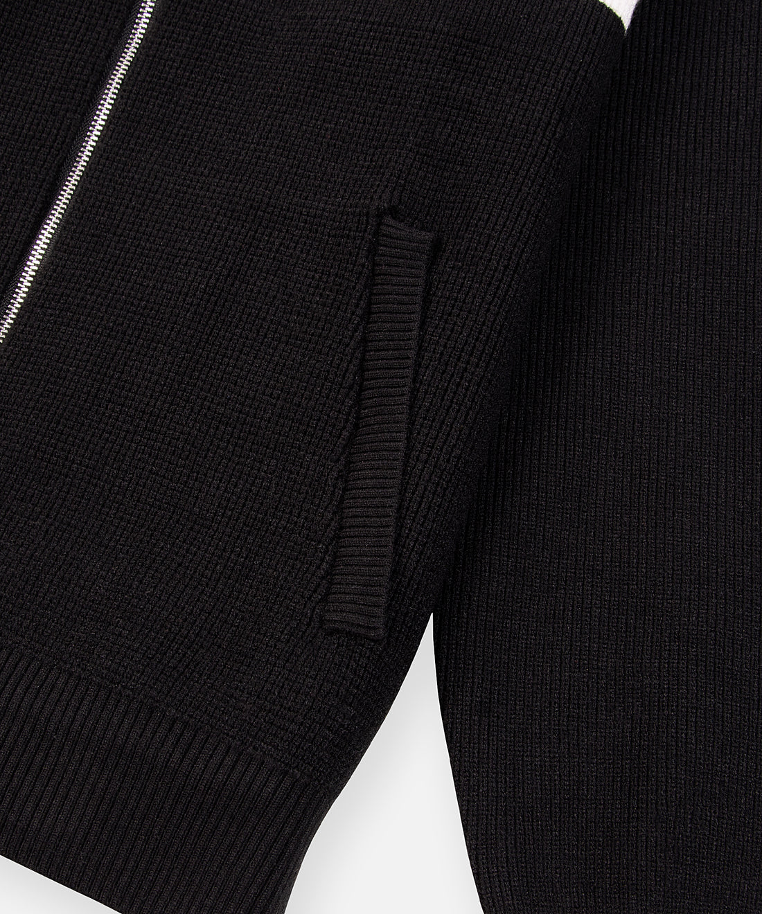 CUSTOM_ALT_TEXT: Front pocket with ribbed single welt opening on Paper Planes Sweater Track Jacket, color Black.