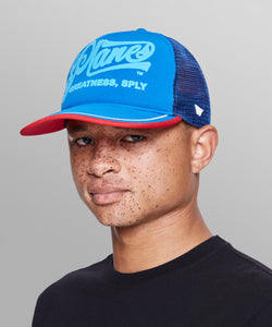 CUSTOM_ALT_TEXT: Male model wearing Planes Greatness Trucker Hat color Nautical Blue.